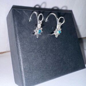 silver 3/4 hoops with a small iridescent star charm